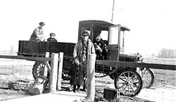 Grandfather Baumberger at the East Gate of the Farmhouse with Model T