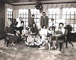 Scully Family Portrait, 1960: (front)Thomas, Michael, and Nadine Scully; (seated) Violet, nanny Anna Lisa with John, Merida, nanny Brenda with Richard, (back) Watkin Lewis, Michael Scully, Peter Scully and his son David